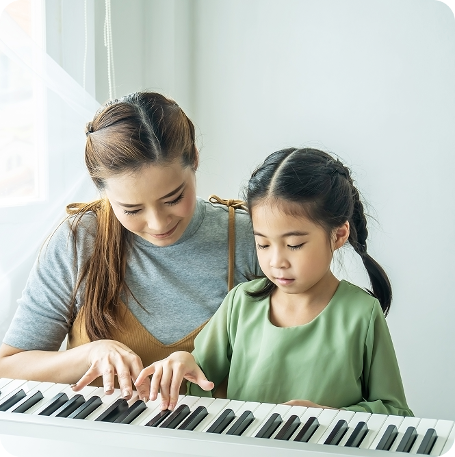 Siblings playing musical instruments together at home